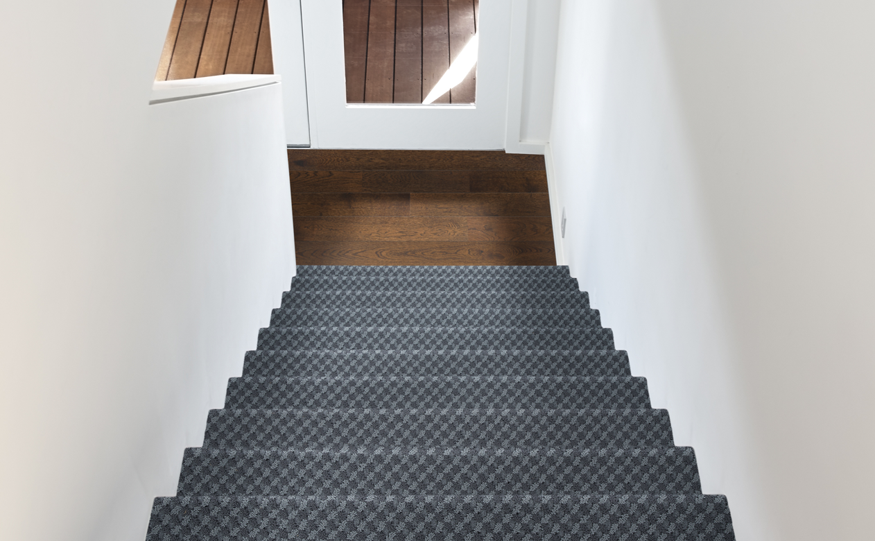 grey toned stair runner with hardwood flooring